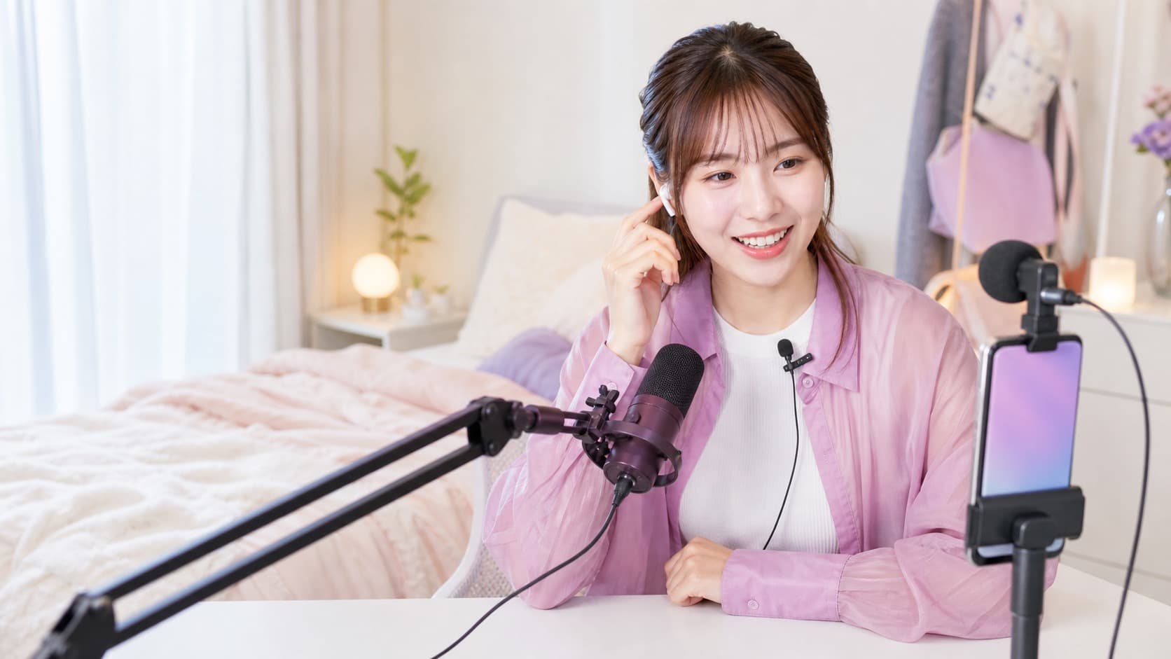スマートフォン、卓上マイク、ピンマイクを使ってライブ配信の音声を確認する女性